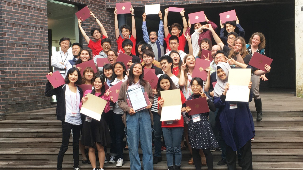 Students holding their certificates
